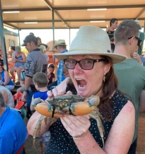 Person holding up large ble claw crab
